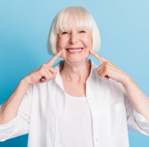 senior woman pointing at Dentures