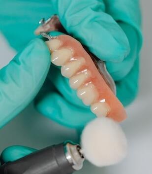 Denturist making dentures