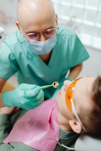 child being examined by a pediatric dentist
