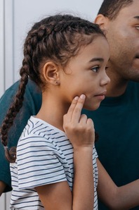 child with jaw pain due to teeth grinding